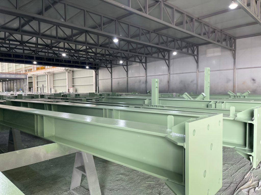 Coated built-up structural steel girders with bolted end plates in the HENZO fabrication shop