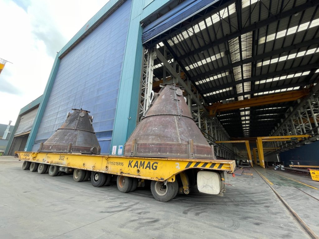 Heavy structural steel beams and columns fabricated by HENZO, packed and strapped for export shipment